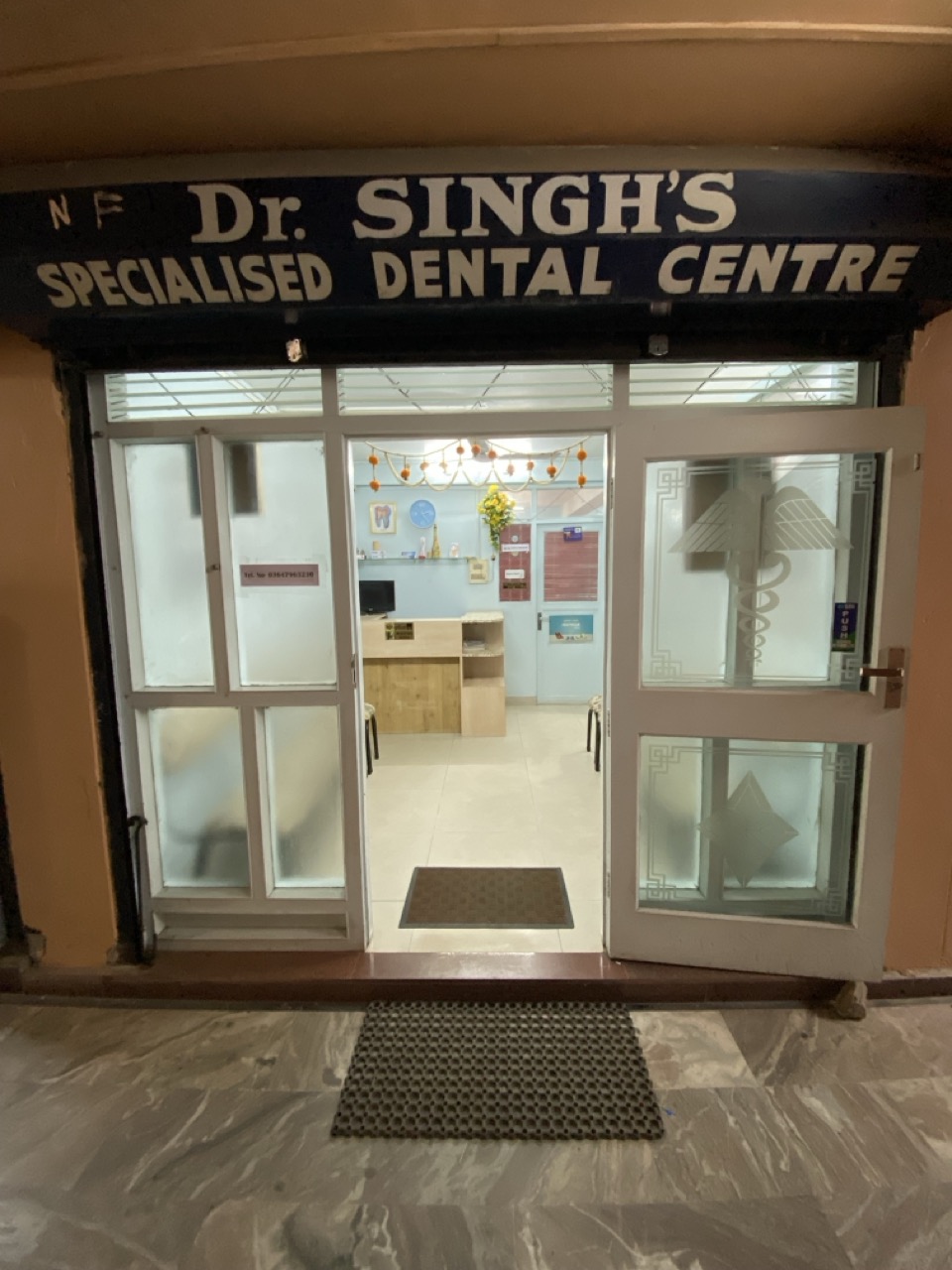 Exterior entrance of Dr. Singh's Specialised Dental Centre at night