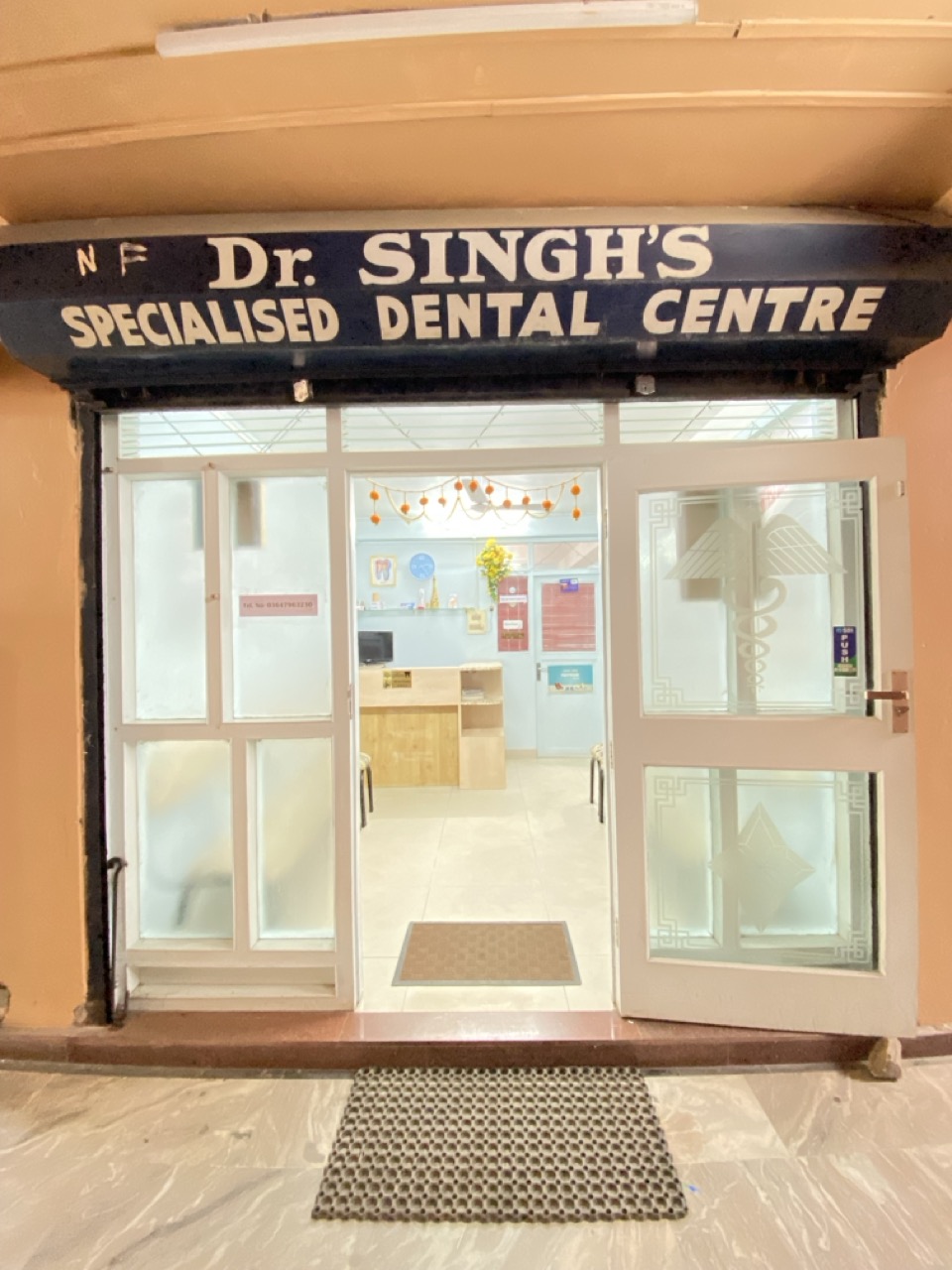 Illuminated exterior signage of Dr. Singh's Specialised Dental Centre