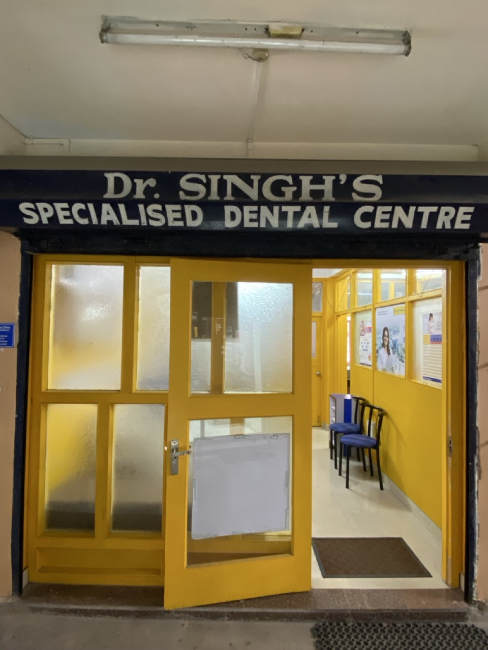 Front entrance with yellow doorway and clinic signage