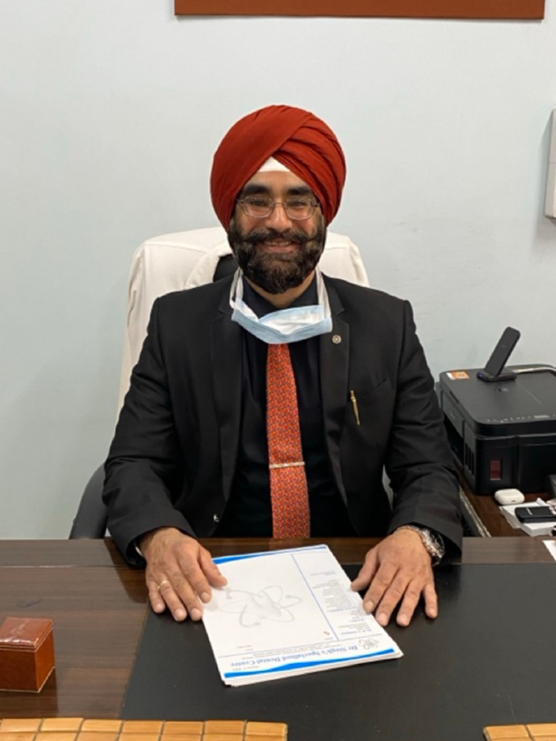 Dr. Kamaljeet Singh Sehdave seated at consultation desk