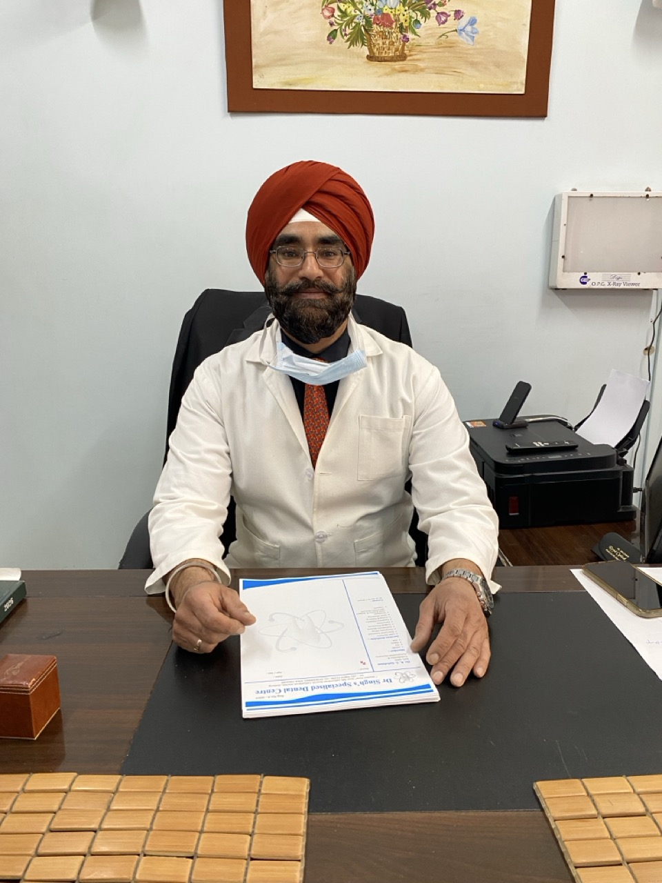 Dr. Kamaljeet Singh Sehdave seated at consultation desk