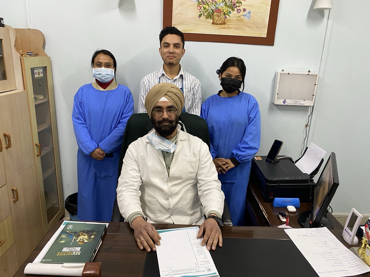 Wide group portrait of Dr. Singh's Specialised Dental Centre team