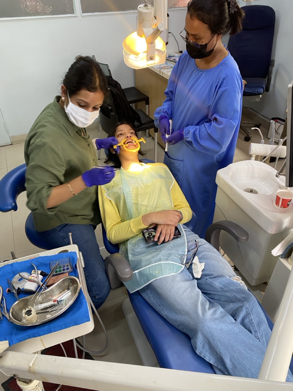 Dental procedure in progress with team support