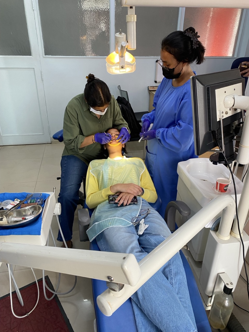 Dental treatment session with team coordination