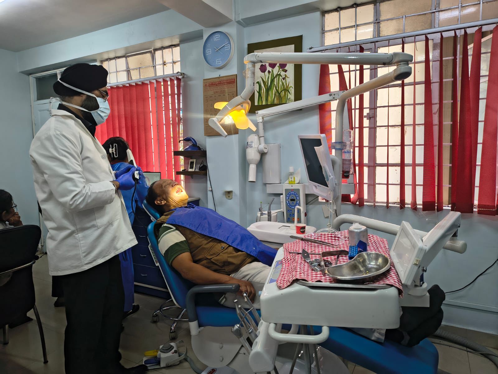 Alternate angle of dental treatment session in progress